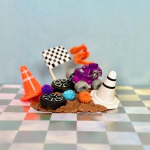 Monster Truck play dough jar featuring non-toxic play dough scented in cocoa.  Monster Jam theme accessories include two cones, two tires, flag, tinsel Pom poms and colorful pipe cleaner.  Great for sensory play, on the go/travel, screen-free entertainment.