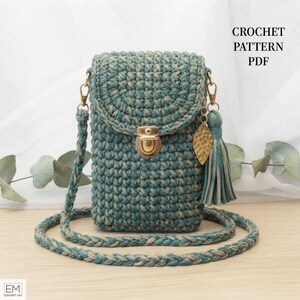May include: A teal and beige crochet crossbody bag with a braided strap, a gold-tone metal push-lock closure, and a matching tassel charm with a gold leaf-shaped pendant. The text CROCHET PATTERN PDF is visible in the upper right corner.