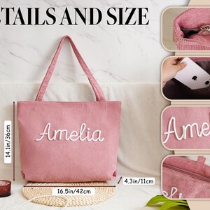May include: A pink corduroy tote bag with the name "Amelia" embroidered in white script. The bag is 14.1 inches (36 cm) high and 16.5 inches (42 cm) wide. The image also shows a bottle of wine and a candle.