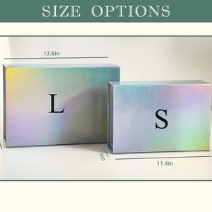 May include: Two iridescent gift boxes, labelled "L" and "S", are displayed. The larger box is 35.1 cm long, 23.9 cm wide, and 11.9 cm high. The smaller box is 29 cm long, 20.1 cm wide, and 9.9 cm high. The text "SIZE OPTIONS" is at the top.