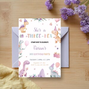 May include: A birthday invitation with a dinosaur theme. The invitation features illustrations of dinosaurs, balloons, and gifts, with text that reads "She's a THREE-REX" and details for a 3rd birthday party. The invitation is on a white background.
