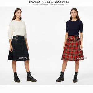 May include: Two women wearing Scottish kilts. One kilt is green and black plaid, the other is red and yellow plaid. Both kilts are knee-length and have buckle details. The text "MAD VIBE ZONE" is at the top.