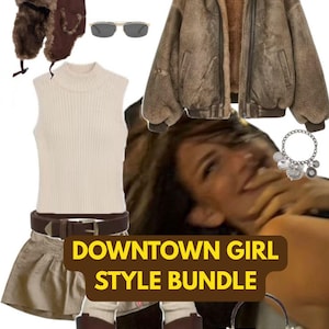 May include: A clothing collection featuring a brown faux fur trapper hat, beige sleeveless mock neck top, brown leather belt, tan skirt, brown bomber jacket with faux fur lining, brown platform boots, a dark red handbag, sunglasses, and a charm bracelet.