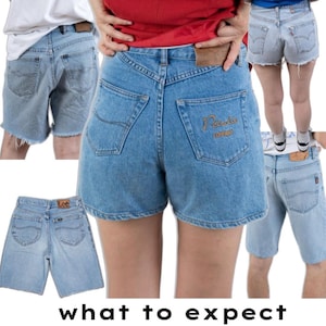 May include: A collection of light blue denim shorts featuring various back pocket designs, including one pair with the embroidered text 'Petrolic Company' on the right pocket and another pair with a brown 'Lee' brand patch on the waistband.