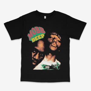 May include: Black t-shirt with a graphic print of the hip-hop duo Mobb Deep. The graphic features a close-up of the two rappers with the group's name in large, colorful letters.