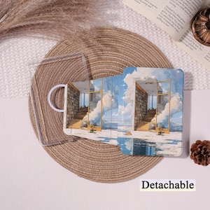 May include: A clear, detachable phone case featuring a printed design of a room with a library and a sky view. The case is open, showing the interior. The word "Detachable" is printed at the bottom.