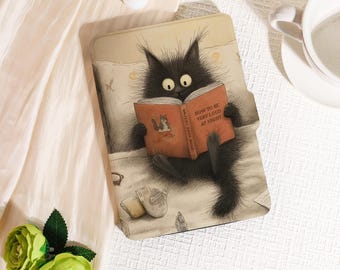 May include: A black cat illustration on a tablet case, reading a book titled "How to be Very Loud at Night." The case has a light beige background with a bed scene, including a pillow, blanket, and a pair of slippers.