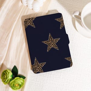 May include: A navy blue tablet case with a pattern of leopard print stars. The case is rectangular with rounded corners and a side pocket. The stars are a tan and brown leopard print.