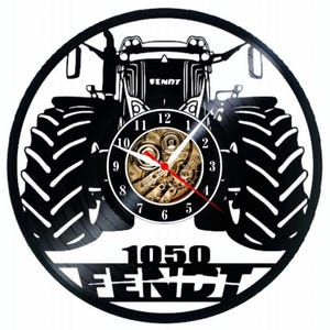May include: Black and white vinyl record clock featuring a silhouette of a tractor with the text "1050 Fendt".