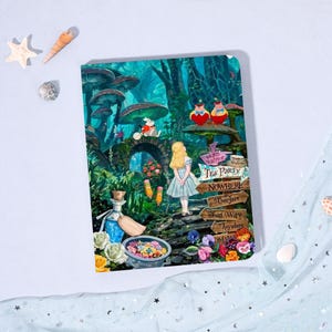 May include: A colorful notebook featuring a whimsical illustration of Alice in Wonderland. The cover depicts Alice in a blue dress, a tea party, and a sign that reads "Tea Party" and "Nowhere". The background is a vibrant forest scene with mushrooms and flowers.