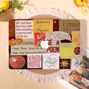 May include: A laptop skin featuring a collage of various text-based quotes and graphics, including phrases like 'Authenticity is Magnetic', 'No Wasted Potential', and 'Practice Empathy', centered around a white Apple logo on a rectangular surface.