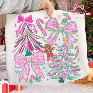May include: White Christmas-themed pillowcase with pink bows, Christmas trees, candy canes, and a gingerbread man. The design includes gold glitter accents and the text "VIBECRAFTEDS STUDIO".
