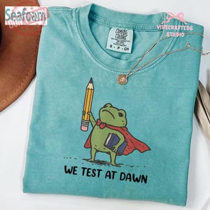 We Test At Dawn Funny Teacher Frog Comfort Colors Shirt, Test Day Teacher Shirt, Teacher Humor Shirt, Exam Day Outfit
