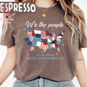 May include: A brown t-shirt with the words "We the people" above a patchwork map of the USA. The map is decorated with red, white, and blue stars and patches. The text "1776-2026 250th Anniversary" is below the map.