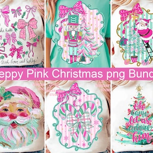 May include: A selection of white sweatshirts featuring preppy pink Christmas designs. The designs include bows, a nutcracker, Santa Claus, candy canes, and a Christmas tree. Text includes "Deck the halls with bows and holly" and "Oh come let us adore him."