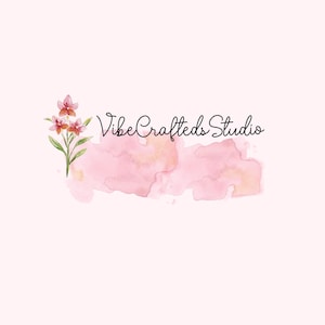 May include: A logo design featuring the text "VibeCrafteds Studio" in a handwritten style. The logo includes a watercolor design of pink and peach hues, with a floral element of pink and orange flowers.