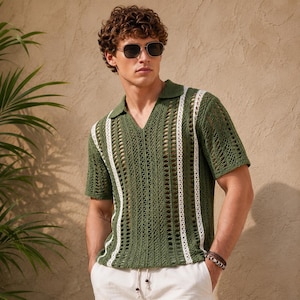 May include: A short-sleeve polo shirt featuring an olive green open-knit crochet texture with vertical white stripes, a collared V-neckline, and a semi-sheer construction. The shirt is paired with white trousers and dark-tinted sunglasses.