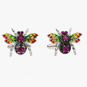 May include: A pair of silver cufflinks in the shape of a bee. The bee's wings are painted with red, yellow, and green enamel. The body features a large, round, purple gemstone and smaller black gemstones.