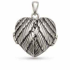 May include: A silver-colored pendant in the shape of a heart with detailed wing designs. The pendant has a loop at the top for a chain. The wings are intricately detailed, giving a textured appearance. The overall design is elegant and symbolic.