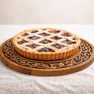 Round wooden tray with Celtic knot border relief, shown with cake, decorative CNC carving design.