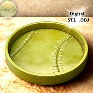 May include: A 3D-rendered, olive-green baseball design. The baseball is set within a matching circular frame. The ball features white stitching details. The words "Digital .STL .OBJ" are visible in the upper right corner.