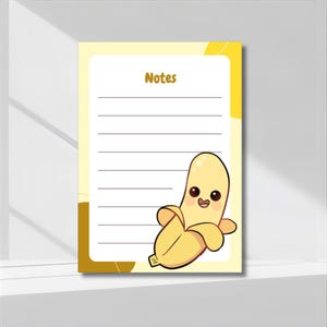 以下が含まれることがあります： 上部に「Notes」という文字が入った黄色のメモ帳。 笑顔の漫画のバナナが右下にあります。 メモ帳には罫線入りのページと黄色の縁があります。