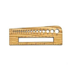May include: A wooden gauge tool with a light brown wood grain finish. It features a series of graduated holes and a ruler along the bottom edge. The tool is marked with millimeter measurements and hole sizes, ideal for crafts and measuring.