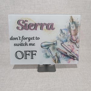 May include: A rectangular sign with the name "Sierra" in a cursive font, and the text "don't forget to switch me OFF." The sign features illustrations of hair styling tools and products, including a hair dryer, straighteners, and spray bottles.