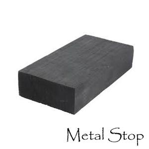 May include: A solid black rectangular block of metal. The block is smooth and has a slightly textured surface. The text "Metal Stop" is printed in black on a white background below the block.
