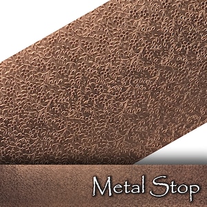 May include: A copper-colored metal sheet with a floral pattern. The sheet is angled, revealing a textured surface. The words "Metal Stop" are displayed in a white, stylized font at the bottom of the image.