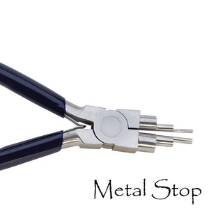 May include: A pair of silver metal pliers with dark blue handles. The pliers have multiple rounded tips of varying sizes. The text "Metal Stop" is written in a cursive font below the pliers.