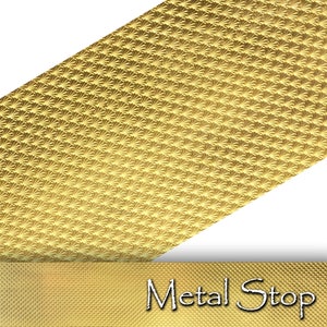 May include: A close-up of a gold-colored metal sheet with a repeating fan-like pattern. The sheet is angled, revealing a textured surface. The bottom of the image shows a gold band with the text "Metal Stop".