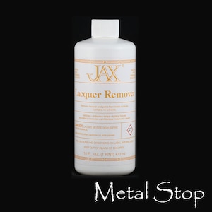 May include: A white plastic bottle of JAX Lacquer Remover with a white cap. The label includes the product name, instructions, and a warning. The bottle contains 16 fl. oz. (1 pint) or 473 ml of product.