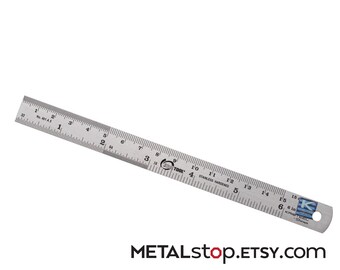 6 inch Precision Stainless Steel Ruler .5mm marks and .64th inch marks bonus inch to mm conv. chart on back. Drilled hole for easy hanging.