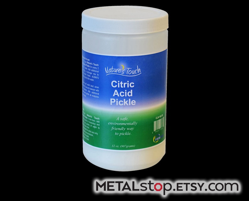 May include: A white plastic jar with a blue and green label that reads "Nature's Touch Citric Acid Pickle". The label also says "A safe, environmentally friendly way to pickle." and "32 oz. (907 grams)".