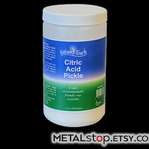 May include: A white plastic jar with a blue and green label that reads "Nature's Touch Citric Acid Pickle". The label also says "A safe, environmentally friendly way to pickle." and "32 oz. (907 grams)".