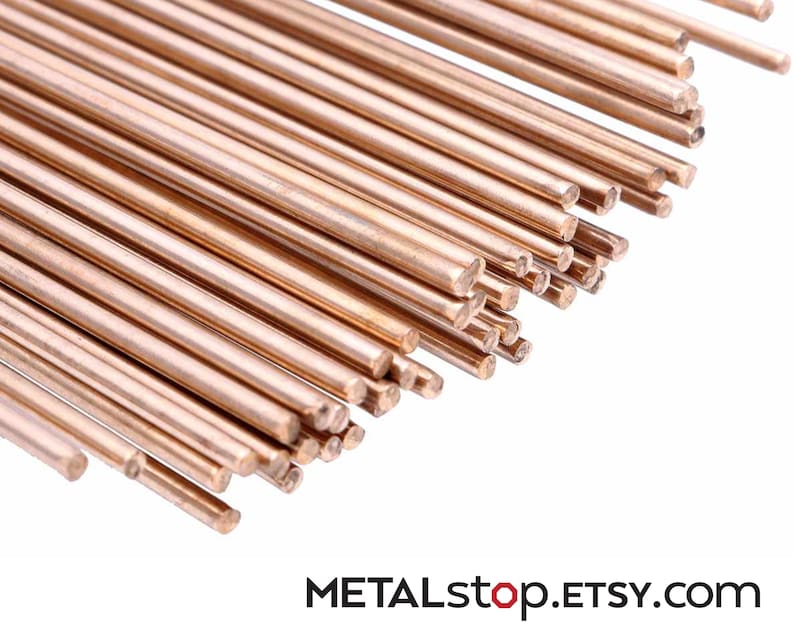 Pode incluir: Um conjunto de varetas met&aacute;licas de cor cobre, dispostas diagonalmente sobre um fundo branco. As varetas s&atilde;o cil&iacute;ndricas e parecem ter um comprimento uniforme. O texto "METALstop.ETSY.com" &eacute; vis&iacute;vel na parte inferior.