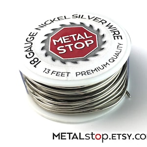 May include: A spool of 18-gauge nickel silver wire. The white spool has a red and white label with the text "METAL STOP" inside a stop sign shape. The spool contains 13 feet of premium quality wire.