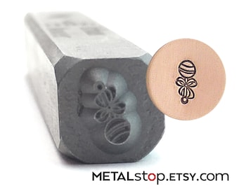 Baby Rattle Metal Design Stamp for baby themed jewelry designs measures 4.5 mm x 2.5 mm when stamped. Made from heat-treated tool steel.