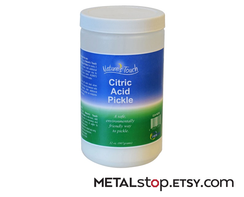 May include: A white plastic jar with a blue label that reads "Nature's Touch Citric Acid Pickle". The label also says "A safe, environmentally friendly way to pickle." and "32 oz. (907 grams)".