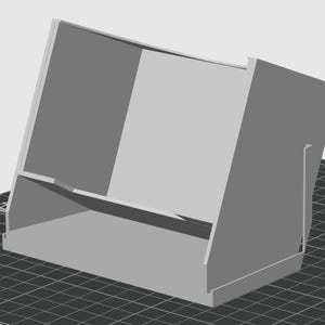 May include: A light gray, angled display stand with a rectangular base and a sloped back. The stand has a shelf and a support piece on the side. The design is simple and modern, suitable for displaying items.