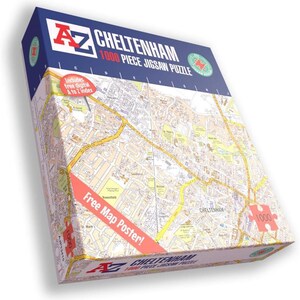 May include: A boxed 1000-piece jigsaw puzzle featuring a detailed map of Cheltenham. The box is primarily white with a map design, and includes the text "Cheltenham 1000 Piece Jigsaw Puzzle". A red banner reads "Free Map Poster!"
