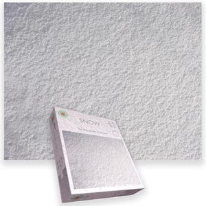 May include: A white puzzle box with the word "SNOW" printed on it, set against a textured white background. The box has a clear window showing the puzzle pieces. The puzzle is from "The Impuzzables Collection".