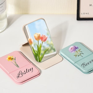 May include: A set of three ceramic mugs with a speckled, matte finish. The mugs are in shades of cream, light gray, and dark gray. Each mug has a simple, minimalist design and a rounded handle.