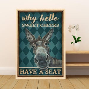 May include: A vintage-style poster featuring a donkey with the text "Why hello sweet cheeks have a seat" in a gold font on a teal and white diamond pattern background.