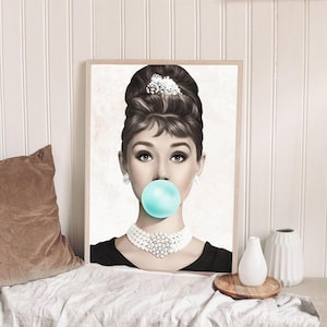 May include: A black and white illustration of a woman with a large, blue bubble gum in her mouth. She is wearing a pearl necklace and has her hair styled in a bouffant.