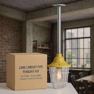 May include: A yellow and silver pendant light with a caged shade and a visible lightbulb. A cardboard box with the text "LONG CONDUIT PIPE PENDANT KIT" is next to the light. The fixture is designed for an E27 base bulb.