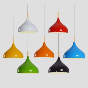 May include: A selection of pendant lights in a range of colours: white, red, yellow, orange, green, black, and blue. Each light has a glossy finish, a wooden accent, and a simple, modern design. The lights are suspended from the ceiling.