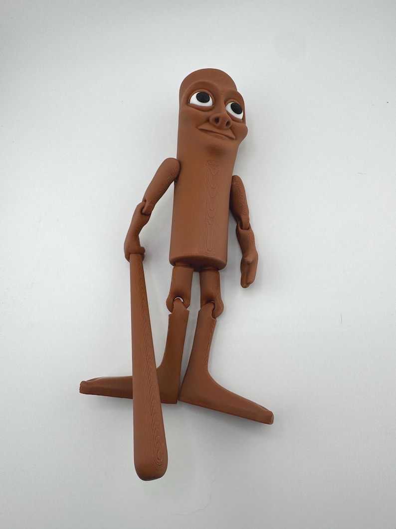 May include: A brown articulated figure with a cylindrical body, arms, and legs. The figure has a smiling face and is holding a brown baseball bat. The figure's limbs are jointed, allowing for posing. The figure is standing on a white surface.