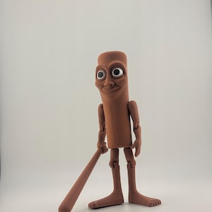 May include: A brown, articulated figurine with a cylindrical body, large eyes, and a smiling expression. The figure is holding a brown, cylindrical object, resembling a baseball bat. The figure has articulated arms and legs, and is standing on a white surface.